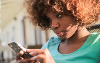 young black woman using her cell phone